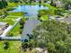 An aerial view of a beautiful landscaped backyard with an lake view and mature trees at 10430 Crestfield Dr, Riverview, FL 33569