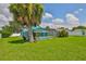 Features a screened in pool with bright turquoise trim and a beautiful palm tree in a spacious fenced in yard at 10430 Crestfield Dr, Riverview, FL 33569