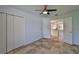 Bedroom with tiled floors, closet, and view into the kitchen, creating a functional space at 10430 Crestfield Dr, Riverview, FL 33569