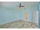 An airy bedroom with a ceiling fan and tile flooring at 10430 Crestfield Dr, Riverview, FL 33569