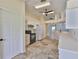 Bright kitchen features white cabinetry, stainless appliances, and plenty of counter space at 10430 Crestfield Dr, Riverview, FL 33569