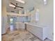 Well-lit kitchen features sleek white cabinetry, tiled floor, and modern countertops at 10430 Crestfield Dr, Riverview, FL 33569