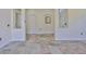 Open-concept living area with tiled floors, recessed shelves, and views of the entry at 10430 Crestfield Dr, Riverview, FL 33569