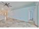 Spacious living room with tiled floors and views into the kitchen and other rooms at 10430 Crestfield Dr, Riverview, FL 33569