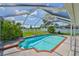 Screened in pool with brick trim, surrounded by greenery, offers a relaxing outdoor space at 10430 Crestfield Dr, Riverview, FL 33569