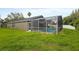 This grassy backyard is completed with screened-in pool, surrounded by lush greenery and privacy at 10462 Lucaya Dr, Tampa, FL 33647