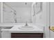 Bright bathroom with a sink, dark brown cabinets and white tiled floor at 10462 Lucaya Dr, Tampa, FL 33647