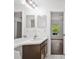 Bathroom with a sink, a large mirror and a view into the bedroom at 10462 Lucaya Dr, Tampa, FL 33647