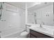 Bright bathroom with a shower over tub combination, sink, and tiled floor at 10462 Lucaya Dr, Tampa, FL 33647