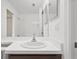 Bathroom with a sink, a large mirror and a shower behind it at 10462 Lucaya Dr, Tampa, FL 33647