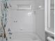 Bright white tile bathtub with a shower-tub combination at 10462 Lucaya Dr, Tampa, FL 33647