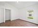 Bedroom with wood floor, a window with natural light, closet with bi-fold doors, and neutral paint at 10462 Lucaya Dr, Tampa, FL 33647