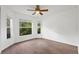 Bedroom with windows overlooking trees, hardwood floors, and ceiling fan at 10462 Lucaya Dr, Tampa, FL 33647