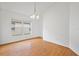 Bright, airy dining room with wood floors, large window, and classic chandelier at 10462 Lucaya Dr, Tampa, FL 33647
