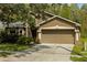 Charming home featuring a two-car garage, neutral-tone stucco, and well-maintained landscaping at 10462 Lucaya Dr, Tampa, FL 33647