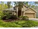 Charming home with tidy landscaping, neutral-tone stucco, and a front-facing two-car garage at 10462 Lucaya Dr, Tampa, FL 33647