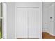 White double door closet near a hallway with light hardwood floors in home at 10462 Lucaya Dr, Tampa, FL 33647