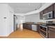 Modern kitchen featuring stainless steel appliances, granite counters, and wooden floors at 10462 Lucaya Dr, Tampa, FL 33647