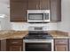 Modern kitchen featuring stainless steel appliances, granite counters, and stylish cabinets at 10462 Lucaya Dr, Tampa, FL 33647