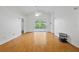 Bright, airy living room with vaulted ceiling, wood floors, and sliding glass door to the lanai at 10462 Lucaya Dr, Tampa, FL 33647