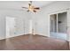 This is a bright, open main bedroom with vaulted ceiling, ceiling fan, and access to the lanai at 10462 Lucaya Dr, Tampa, FL 33647