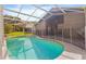 A private screened-in pool area with safety fence offers a serene backyard retreat at 10462 Lucaya Dr, Tampa, FL 33647