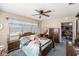 Cozy main bedroom featuring a ceiling fan, dresser, and a doorway to the living room at 105 Melrose Dr, Safety Harbor, FL 34695