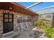 Inviting outdoor patio area with brick paving, a pergola, and comfortable seating for enjoying the outdoors at 105 Melrose Dr, Safety Harbor, FL 34695