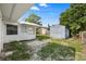 Exterior view of the backyard featuring a shed and partial view of the back of the home at 10730 Premier Ave, Port Richey, FL 34668