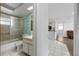 Bright bathroom with tub/shower combo and view to the living area at 10730 Premier Ave, Port Richey, FL 34668