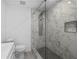 Bathroom featuring a glass shower with stylish marble tiling and a modern shower system at 10730 Premier Ave, Port Richey, FL 34668