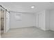 Bedroom featuring gray tile flooring, window, closet and bathroom at 10730 Premier Ave, Port Richey, FL 34668
