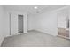 Bedroom featuring gray tile flooring, closet and entry to bathroom at 10730 Premier Ave, Port Richey, FL 34668