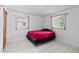 Cozy bedroom with tile flooring, natural light, and a minimalistic design at 10730 Premier Ave, Port Richey, FL 34668
