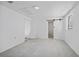 Bedroom featuring gray tile flooring, window, closet and bathroom at 10730 Premier Ave, Port Richey, FL 34668
