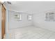 Bedroom showcasing natural light, tile flooring and a minimalistic design at 10730 Premier Ave, Port Richey, FL 34668