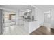 Well-lit kitchen featuring white cabinets and modern appliances at 10730 Premier Ave, Port Richey, FL 34668