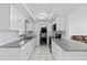 Bright kitchen with white cabinets, granite countertops, and stainless steel appliances at 10730 Premier Ave, Port Richey, FL 34668