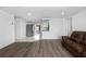 Open-concept living room with modern floors and lots of natural light at 10730 Premier Ave, Port Richey, FL 34668