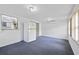 A bright sun room featuring large windows, sliding glass door, and casual flooring at 10730 Premier Ave, Port Richey, FL 34668