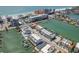 Stunning aerial view of waterfront condos, docks, boats, beach, and cityscape at 120 Brightwater Dr, Clearwater Beach, FL 33767