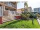 Landscaped backyard with lush green grass, perfect for outdoor activities and relaxation at 120 Brightwater Dr, Clearwater Beach, FL 33767