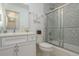 Well-appointed bathroom featuring a vanity, toilet, and shower-tub combination with decorative tile at 120 Brightwater Dr, Clearwater Beach, FL 33767