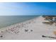 Expansive beach with numerous beach umbrellas and ocean views, offering a serene and picturesque coastal environment at 120 Brightwater Dr, Clearwater Beach, FL 33767