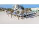 An aerial view of a beachfront restaurant with palm trees and ocean views, offering a relaxing dining experience at 120 Brightwater Dr, Clearwater Beach, FL 33767