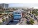 Aerial view of a waterfront location with a pier, buildings, parking, and the open ocean at 120 Brightwater Dr, Clearwater Beach, FL 33767