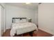 Cozy bedroom with hardwood floors, soft lighting, comfortable furnishings, and a peaceful ambiance for rest at 120 Brightwater Dr, Clearwater Beach, FL 33767