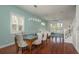 Dining room with seating for six and waterfront views visible through large glass doors at 120 Brightwater Dr, Clearwater Beach, FL 33767