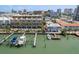 Attractive waterfront condos with private docks, boats, and lush tropical landscaping at 120 Brightwater Dr, Clearwater Beach, FL 33767