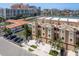 Exterior shot of a three-story townhouse with stucco finish, small balconies, and private parking spaces at 120 Brightwater Dr, Clearwater Beach, FL 33767